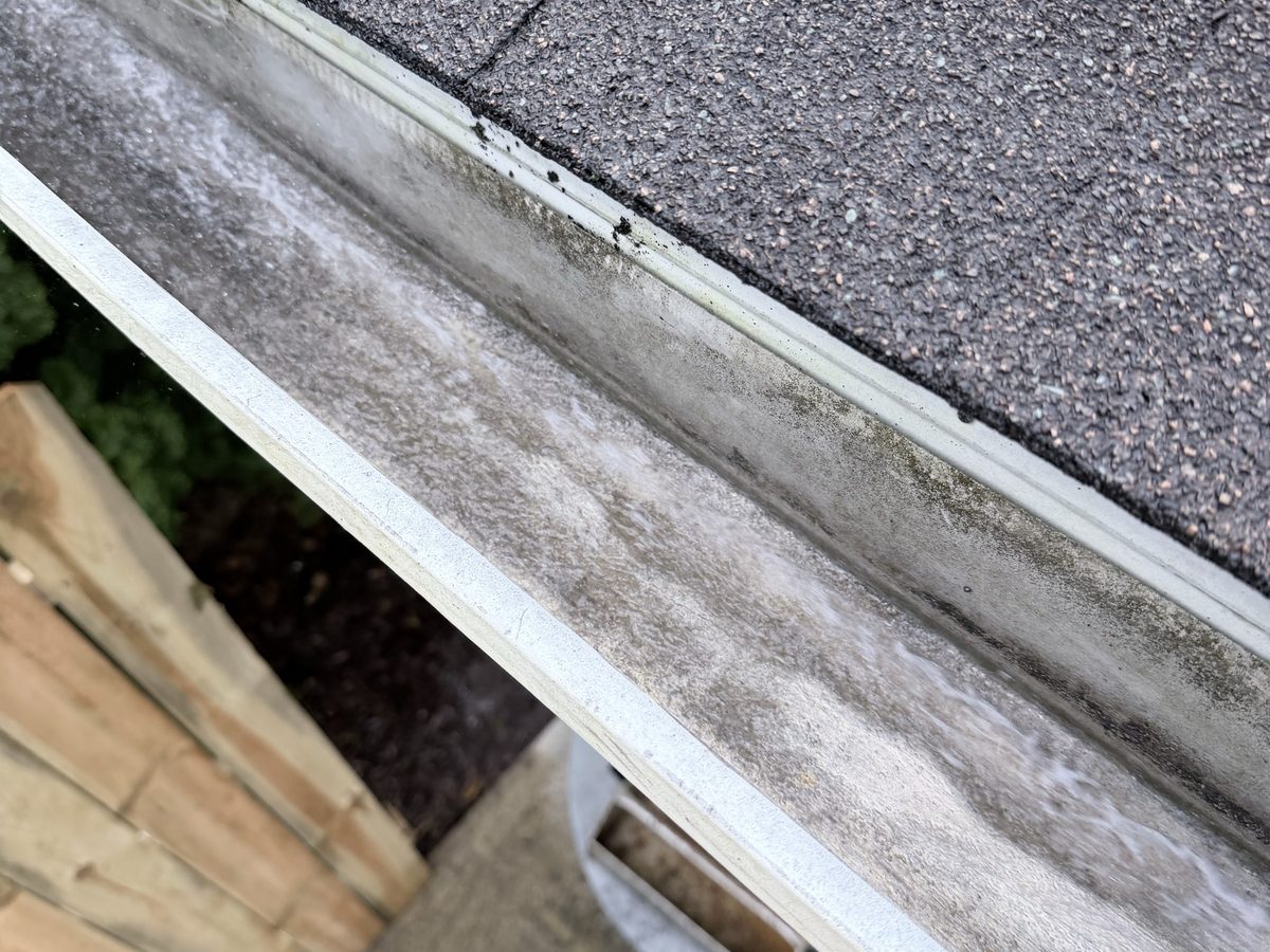 A clean, empty gutter run after a hand cleanout